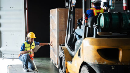 Warehouse worker workers with forklift in a warehouse and use anti slip mats